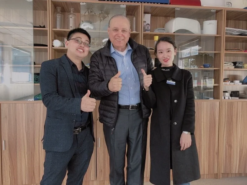 Four people standing in front of HVACore company logo wall with decorative elements and office reception area visible